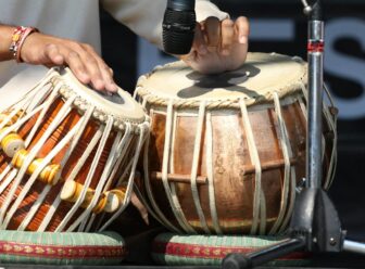 Tabla player performing Indian classical music, reflecting a tradition carried across generations